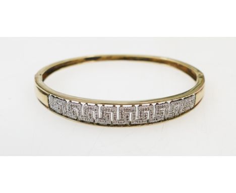 Yellow coloured metal bangle set with large quantity of small diamonds: Diamonds indicated as 0.25ct on inside.  Weight 12.8g