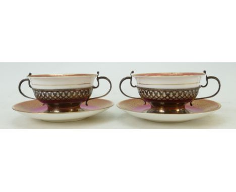 Pair of Cauldon cups in hallmarked silver baskets:  Silver baskets hallmarked for 1934. Tiny stain to one saucer.