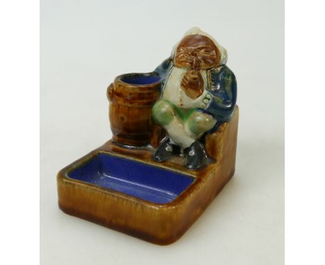 Doulton Lambeth Stoneware Match Striker of a seated man: Match Striker by Doulton Lamberth of a seated man with a barrel smok