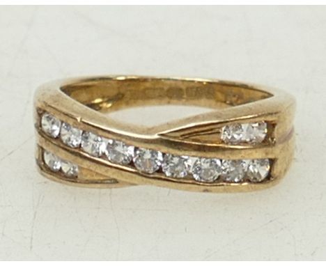 9ct gold Crossover dress ring: Ring set with CZ stones, size K, 3.6grams.