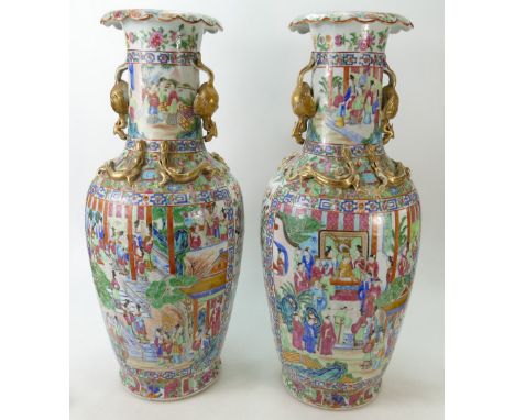 Pair of 19th Century Cantonese Famille Rose decorated vases: Vases with court scene decoration, height 62cm (large chip to on