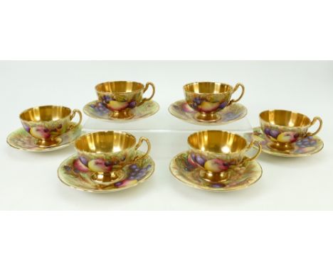 A collection of Aynsley gilded tea cups and saucers: Aynsley cups and saucers decorated with various fruit by N Brunt. (12)