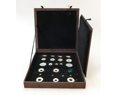 A collection of Chinese various jade buttons: Buttons and discs of various shapes and sizes in display case, Provenance Colle