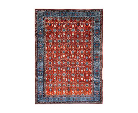 Veramin Carpet Central Iran, circa 1950The brick-red field with columns of flowerheads enclosed by sky blue borders of flower