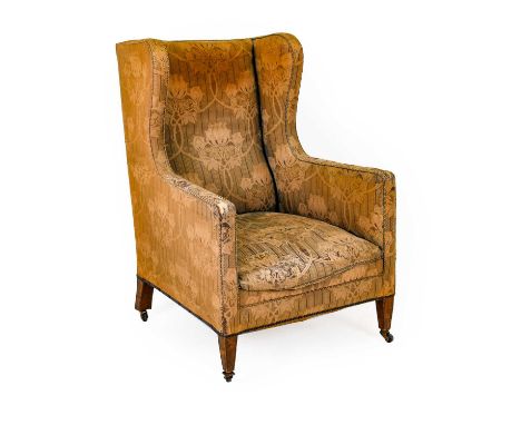 ^ A Victorian Armchair, late 19th century, recovered in worn and faded blue and gold floral fabric, the overstuffed seat with