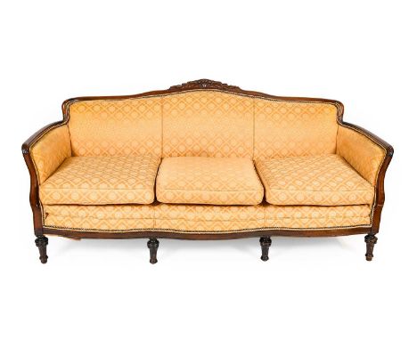 A Late 19th Century Mahogany-Framed and Feather-Filled Three-Seater Sofa, recovered in yellow and gold floral close-nailed fa