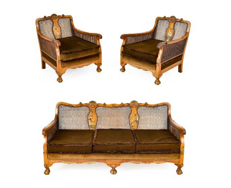 An Early 20th Century Walnut and Chinoiserie Decorated Double-Caned Three-Piece Bergere Suite, comprising a three-seater sofa