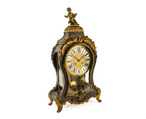 A French "Boulle" Striking Table Clock, retailed by Meyer A Paris, circa 1850, surmounted by a putti, floral and scroll decor