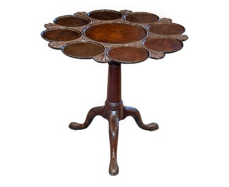 A George III Design Supper table, the shaped circular top with a central dish ring surrounded by nine smaller rings, raised o
