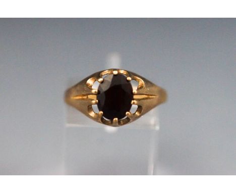 A yellow metal single stone ring set with an oval garnet. hallmarked 9ct gold, Birmingham Size: R 2.2 grams