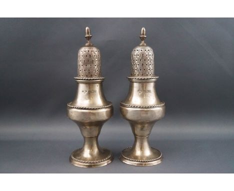 A pair of silver casters each with an acorn finial and of baluster form, 14cm high, Birmingham 1978, 159 grams