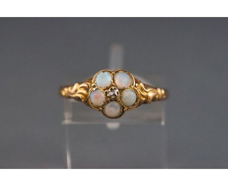 A late Victorian gold, opal and diamond cluster ring, centred with a small rose diamond within five round cabochon opals, bet