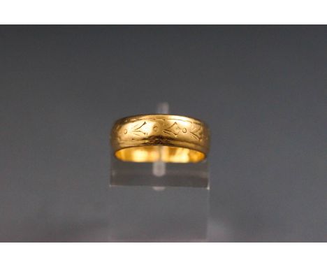 A yellow metal engraved D shape wedding ring. hallmarked 22ct gold, Birmingham, 1967 CG&S Size: K leading edge 5.0 grams