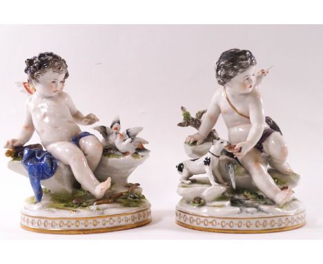A pair of 19th century Continental porcelain figures of Putti, one with a dog and the other with birds, factory mark 'R' to u