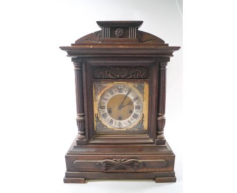 A late 19th century oak cased chiming mantel clock by Junghams, key and pendulum, 44cm high