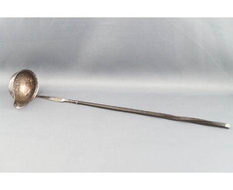 A George III silver punch ladle, engraved with a crest and with a spiral twist horn hand