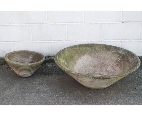 A large re-constituted stone planter of conical form, 31cm high x 90cm diameter, and a smaller example, 26cm high x 47cm diam