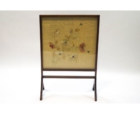 An Edwardian mahogany firescreen with raised embroidered silk flowers, 90cm hgih x 61cm wide