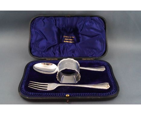 A silver Christening fork, spoon and napkin ring, Sheffield 1909 by Atkin Bros, 98g, in a blue velvet lined leather case