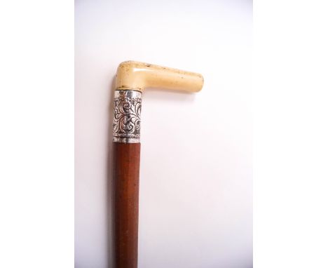 A malacca walking stick with ivory handle and silver collar