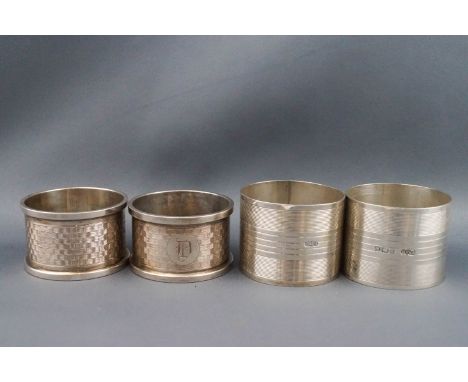 Two pairs of silver engine turned napkin rings, Birmingham 1926, by Henry Mathews and 1921 by E J Houlston, 126g