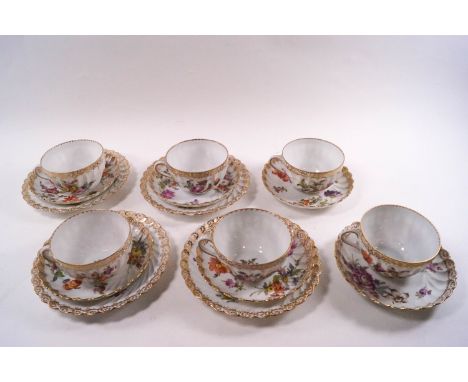 A Dresden porcelain tea service, comprising six cups and saucers and four small plates, hand decorated with flower and gildin