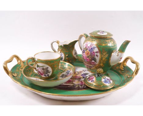 A Sevres early 19th century cabaret set, painted within baskets of flowers and fruit on a marble slab in circular panes on an