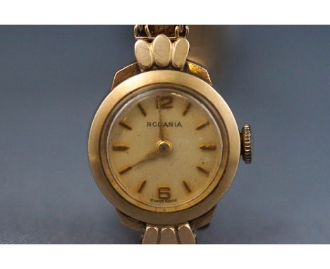 A 9ct gold ladies wristwatch. Round champagne baton dial with integrated bracelet. Manual wind movement. Dial signed Rodania.