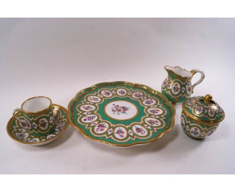 A Sevres cabaret set painted with bouquets and sprays of flowers within oval medallions on an apple green ground, comprising 