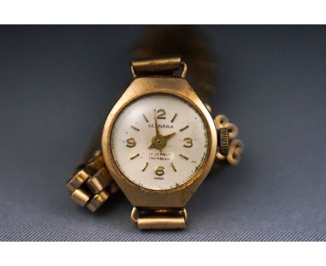 A ladies wristwatch with champagne mix marking dial, signed Leonara. Manual wind 17 jewel movement. Case hallmarked 9ct gold,