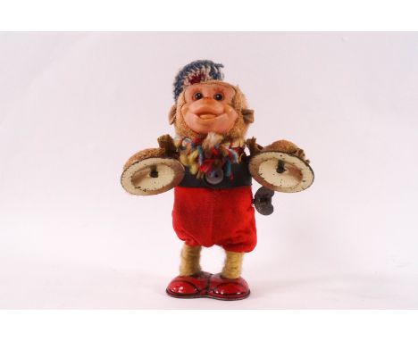 A Japanese clockwork figure of a monkey playing cymbals, 16.5cm high