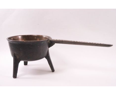An 18th century Wasbrough bronze skillet on three legs, 38cm long