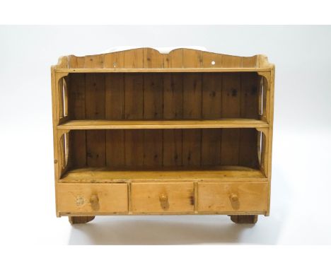 A Victorian pine wall hanging shelf unit with three drawers below three shelves, 79cm high x 89cm wide x 29cm deep