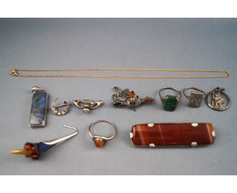 A selection of eleven items of jewellery to include a single earring of blue titanium, silver and amber, a labradorite ingot 