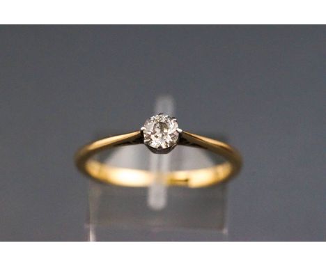 An early 20th century gold and diamond solitaire ring, the old-cut stone approx 0.35cts, claw set in white to a yellow shank,