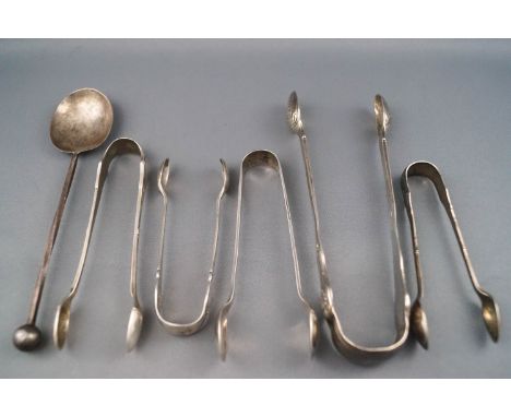 Five silver sugar tongs, George III and later, together with a silver spoon with ball finial, London 1913, 147 grams gross