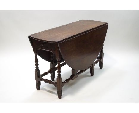 An 19th century oak oval gate leg table, 71cm high x 120cm wide x 45cm deep (un-extended)