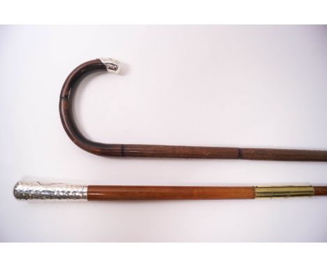 A slim walking cane with 3" silver knop, London 1920 and a walking stick with silver tip, Birmingham 1907