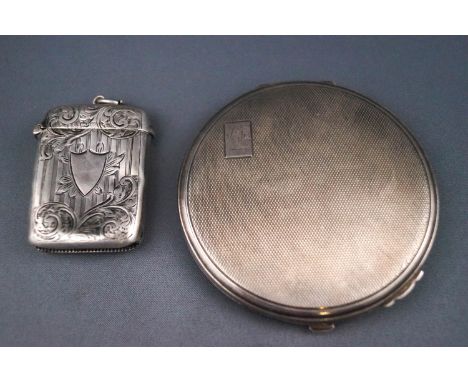 A ladies silver powder compact, of round form with engine turned decoration, the rectangular cartouche engraved B M, 7.6cm di