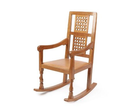 Workshop of Robert Mouseman Thompson (Kilburn): An English Oak Rocking Chair, with two lattice panel backs, shaped arms and c