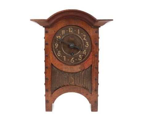 An Arts &amp; Crafts Oak and Copper Mantel Clock, domed top, oak rivets, the hammered dial with Arabic numerals, above a repo