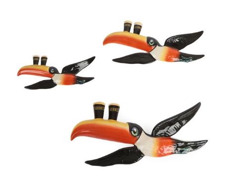 A Set of Three Carlton Ware Guinness Advertising Wall Plaques, each modelled as a flying toucan balancing two My Goodness My 