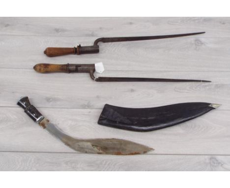 Two bayonets, each mounted on turned wooden handles, one marked 'Wheeler Chapman', the other markings are indistinct, both 26