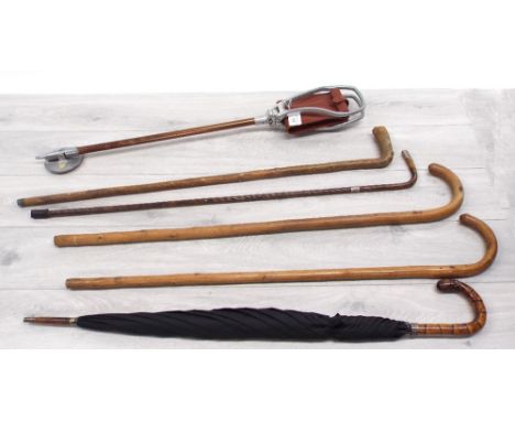 Four walking sticks/canes including one with hallmarked silver collar; together with a modern shooting stick and a gentleman'