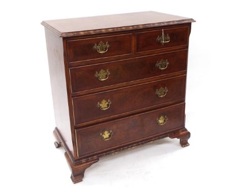 Georgian style walnut veneered chest of drawers, the cross banded moulded top over two short and three long drawers raised on