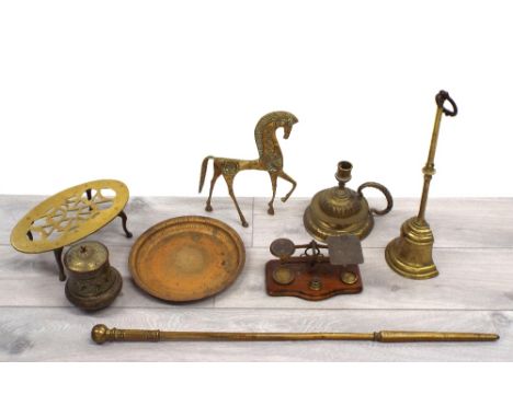 Selection of brass items including door porter, oval trivet, fire poker, Eastern souvenir pot, chamber stick, horse figure an