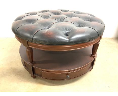A large modern leather button backed centre stool with under shelf and drawers to base. W:110cm x D:110cm x H:60cm
