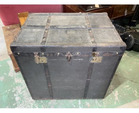 A large German travelling trunk with original label, leather handles to side with material internal lining. With wood and met