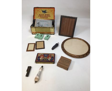 A vintage tin with cigarette card albums and woodbine boxes, a souvenir Frys tin from 1908, photo frames, a circular picture 