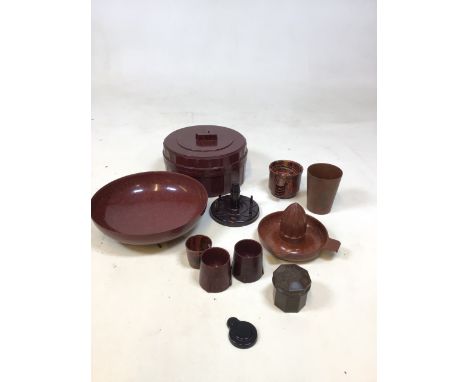 A collection of domestic Bakelite items including a lemon squeezer, a bowl and a large container, egg cups and others 